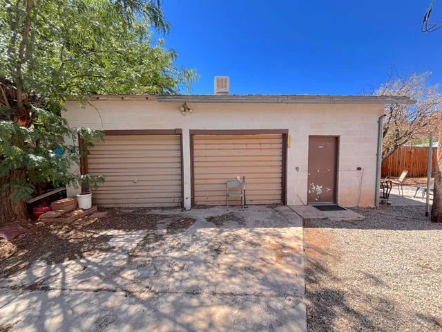 Detached two-car garage with roll-up doors and a separate entry door
