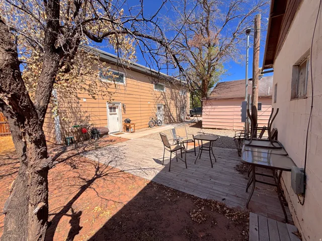 Outdoor patio space featuring wood-finish decking and gravel areas