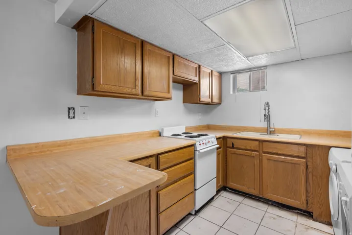 Efficient kitchen space featuring wood-finish cabinetry and countertops
