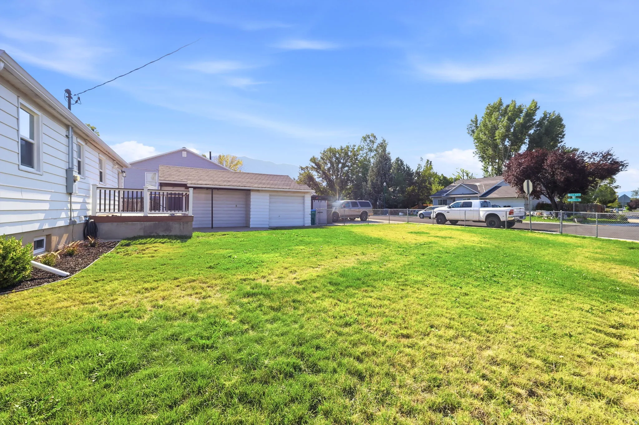 Expansive lawn area with a fenced perimeter