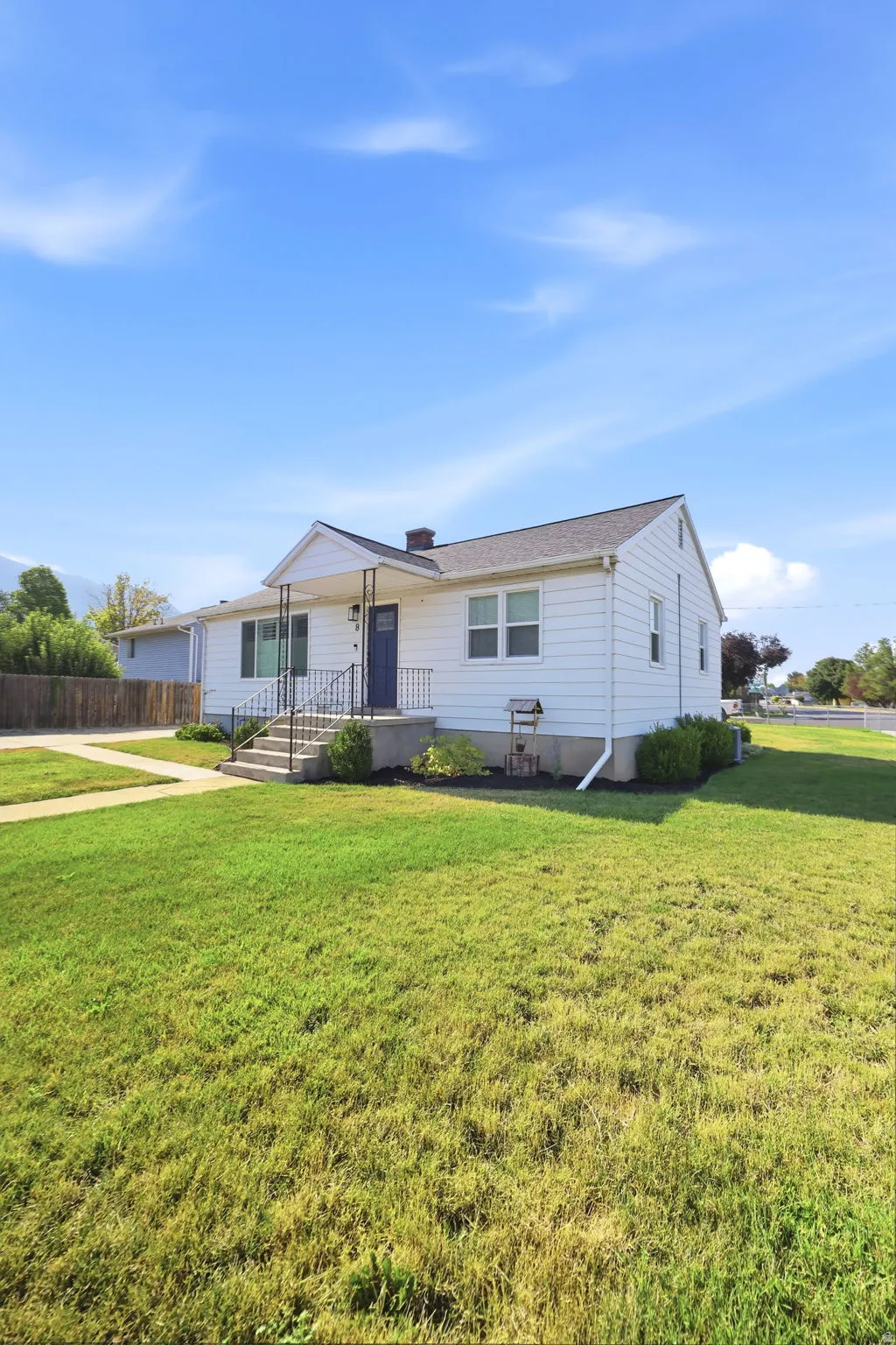 White siding exterior with a contrasting blue front door and white trim