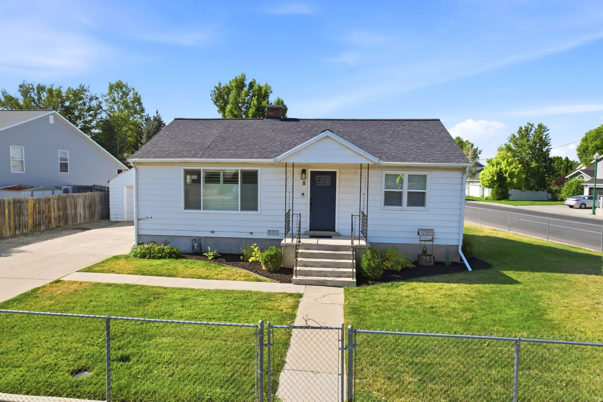 White exterior siding with a dark asphalt shingle roof