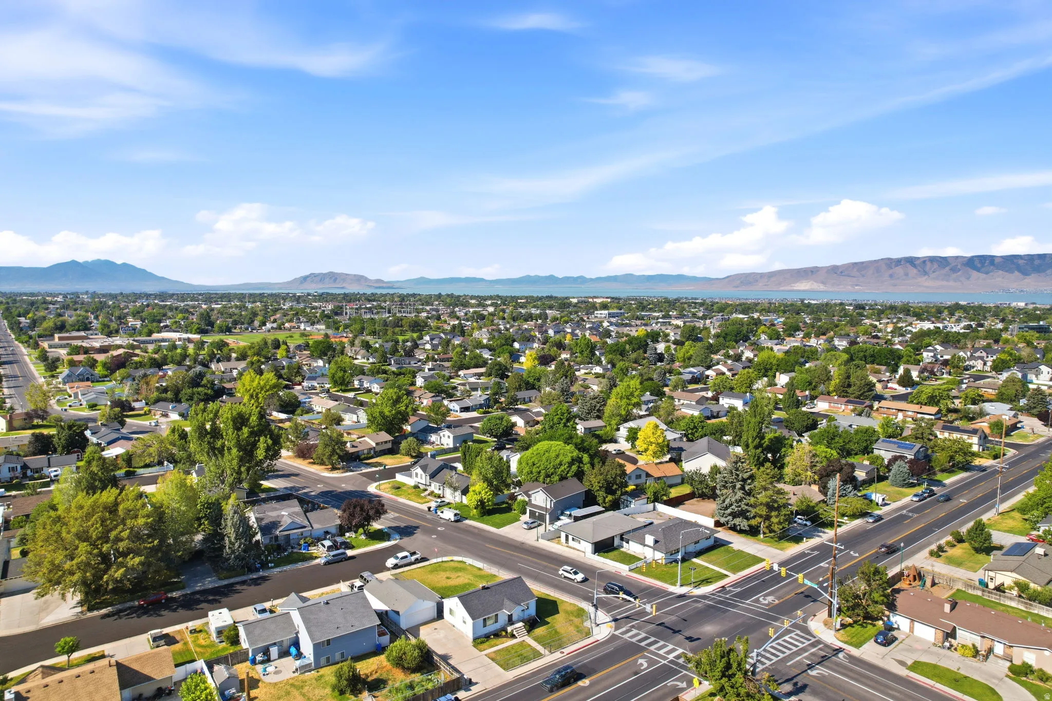 Expansive aerial perspective showcasing a residential neighborhood with tree-lined streets and established homes