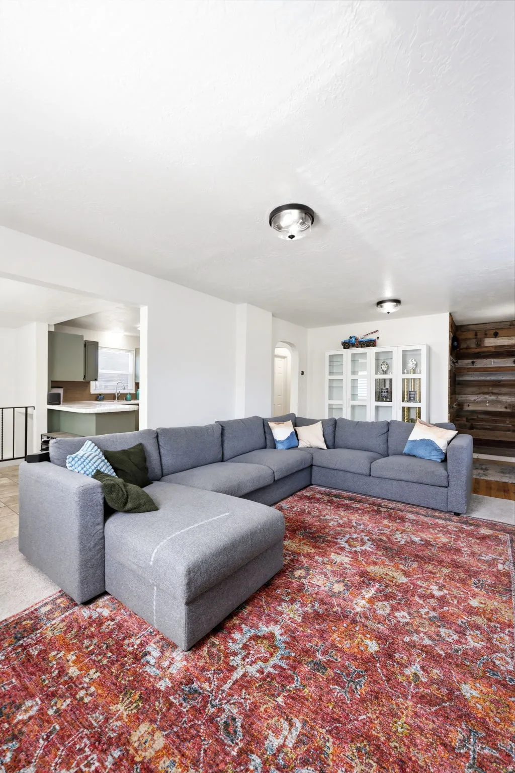 Spacious living area featuring neutral walls and ceiling