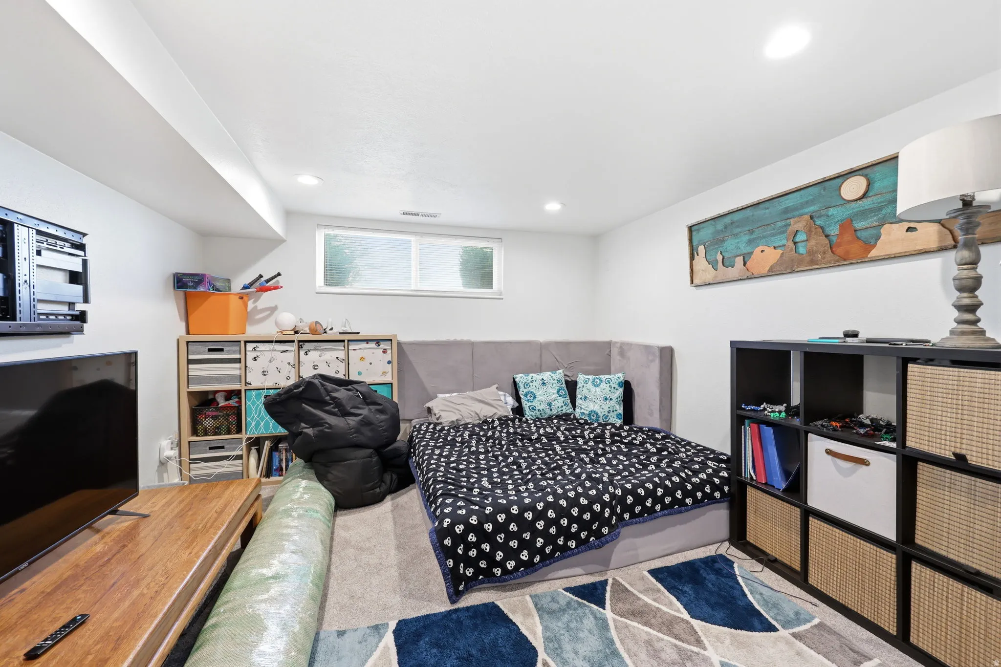 Carpeted room with recessed lighting and a window offering natural light