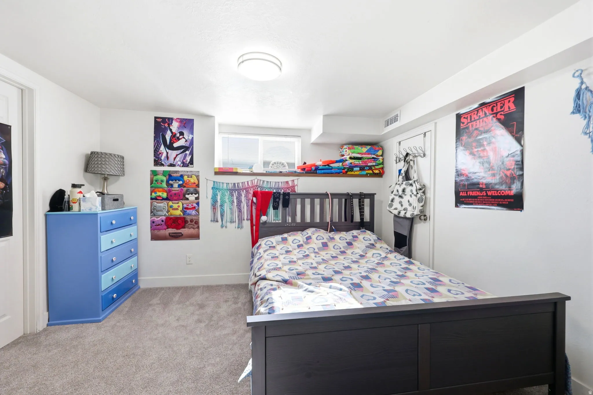 Bright room featuring white walls, gray carpet flooring, a built-in recessed window, and a flush mount ceiling light