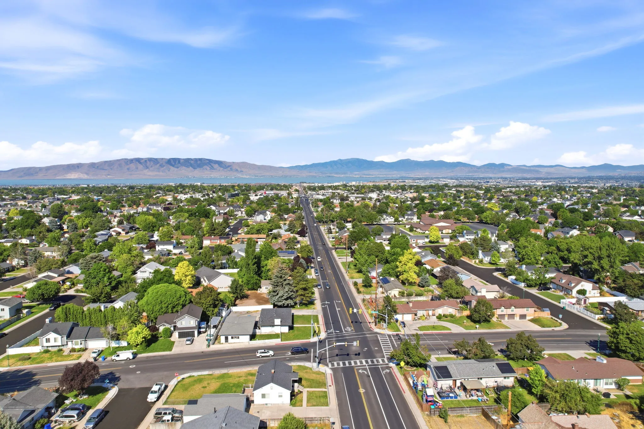 Expansive residential neighborhood featuring mature trees and a clear sky backdrop