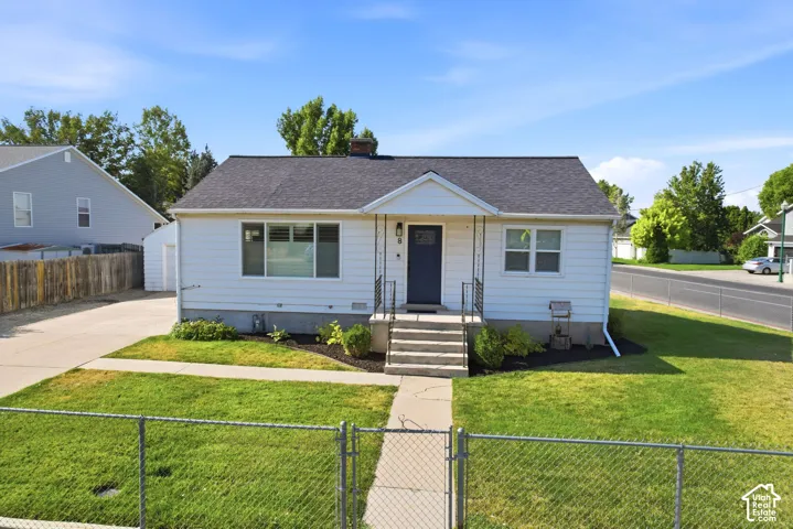 White exterior siding with a dark asphalt shingle roof
