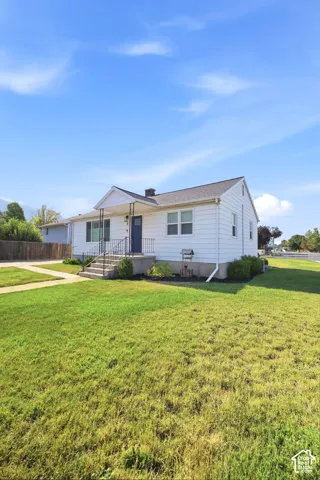 White siding exterior with a contrasting blue front door and white trim