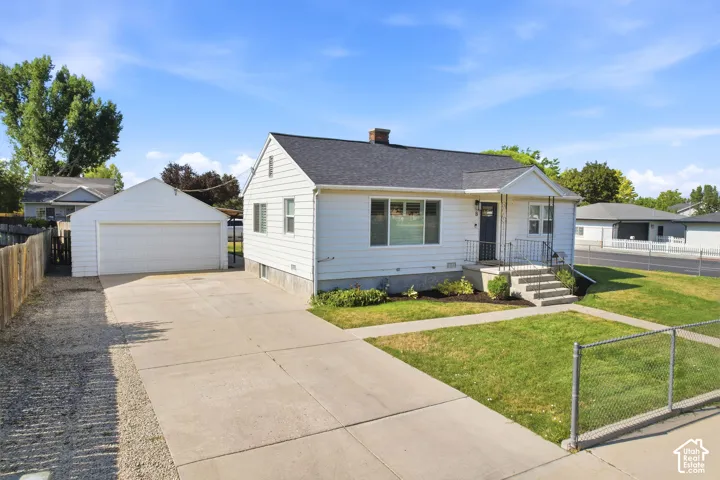 White siding residence with a dark roof and a covered entryway