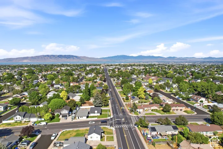 Expansive residential neighborhood featuring mature trees and a clear sky backdrop