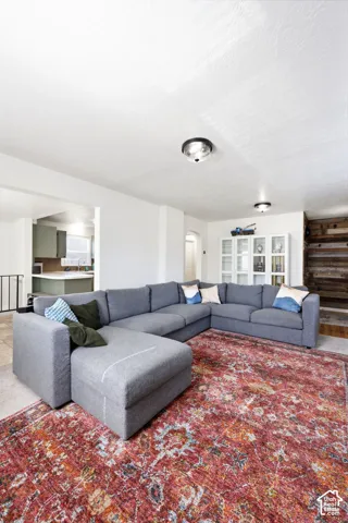 Spacious living area featuring neutral walls and ceiling