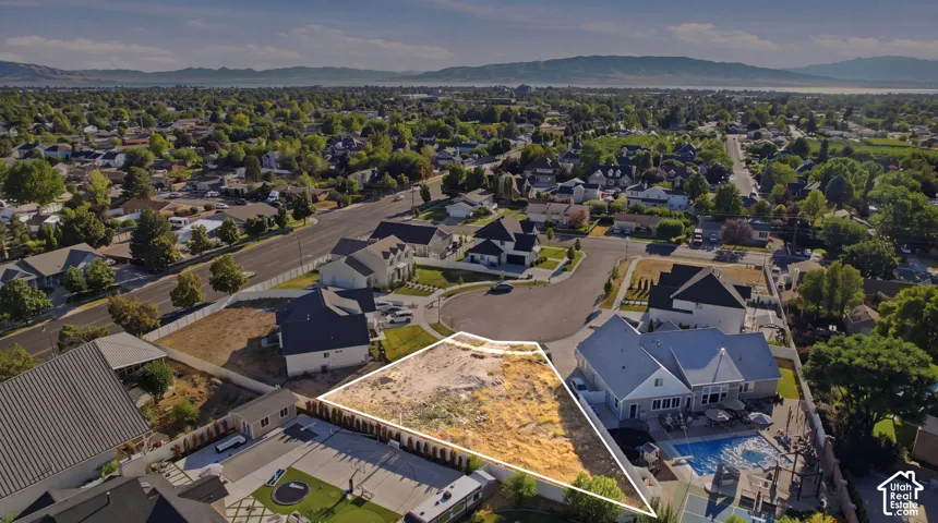 Expansive vacant land parcel featuring a level building site, surrounded by established residences