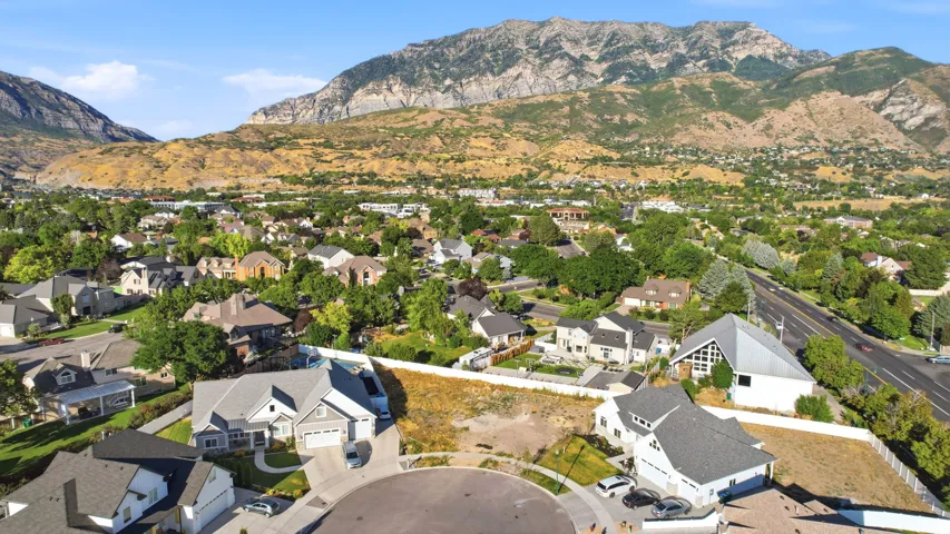 Residential properties situated on a cul-de-sac, featuring landscaped yards and paved driveways