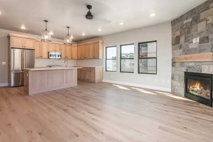 Spacious open-concept area featuring light wood-finish flooring