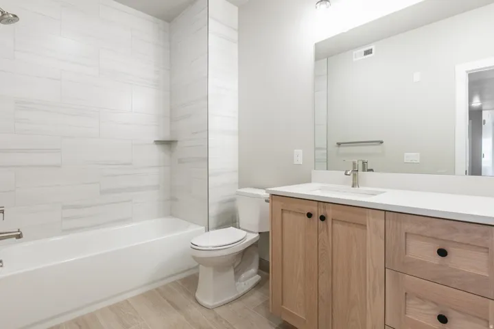 Bathroom featuring a single vanity with wood-finish cabinetry and a white countertop