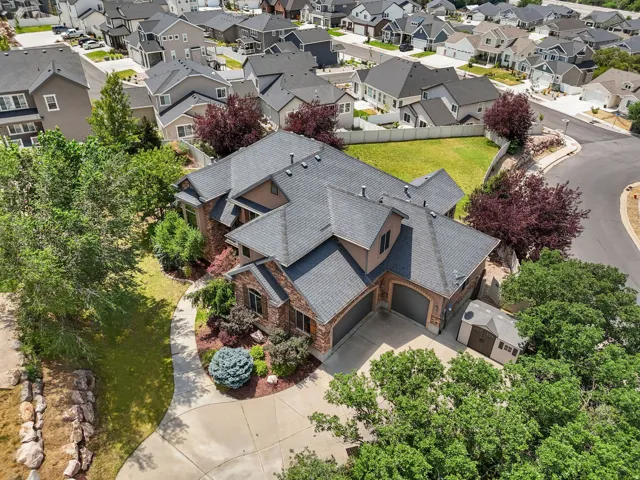 Two-story residence featuring a shingle roof, brick and stucco exterior, and an attached two-car garage