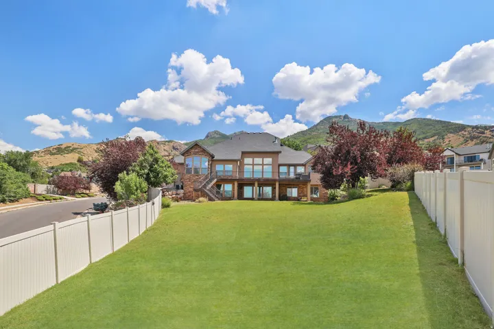 Expansive green lawn with a privacy fence
