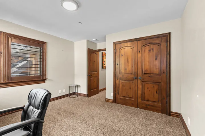 Room featuring textured carpeting, light-toned walls, and a flush-mount ceiling light