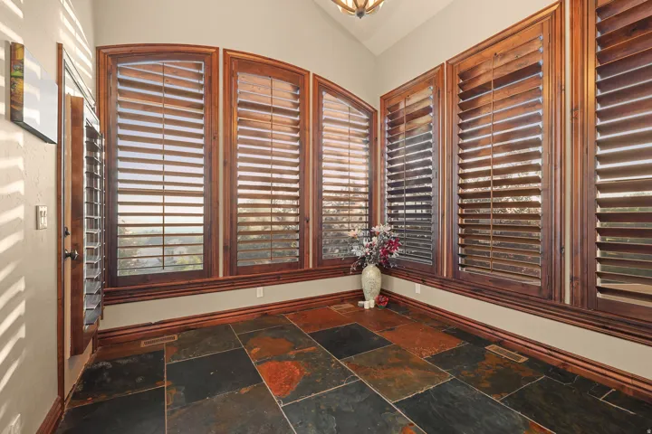 Dining room with slate tile flooring with varied natural tones