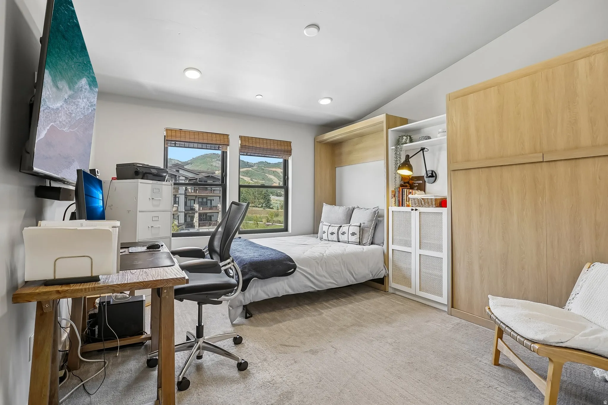 Room featuring wood-finish flooring, recessed lighting, and a built-in wall bed unit