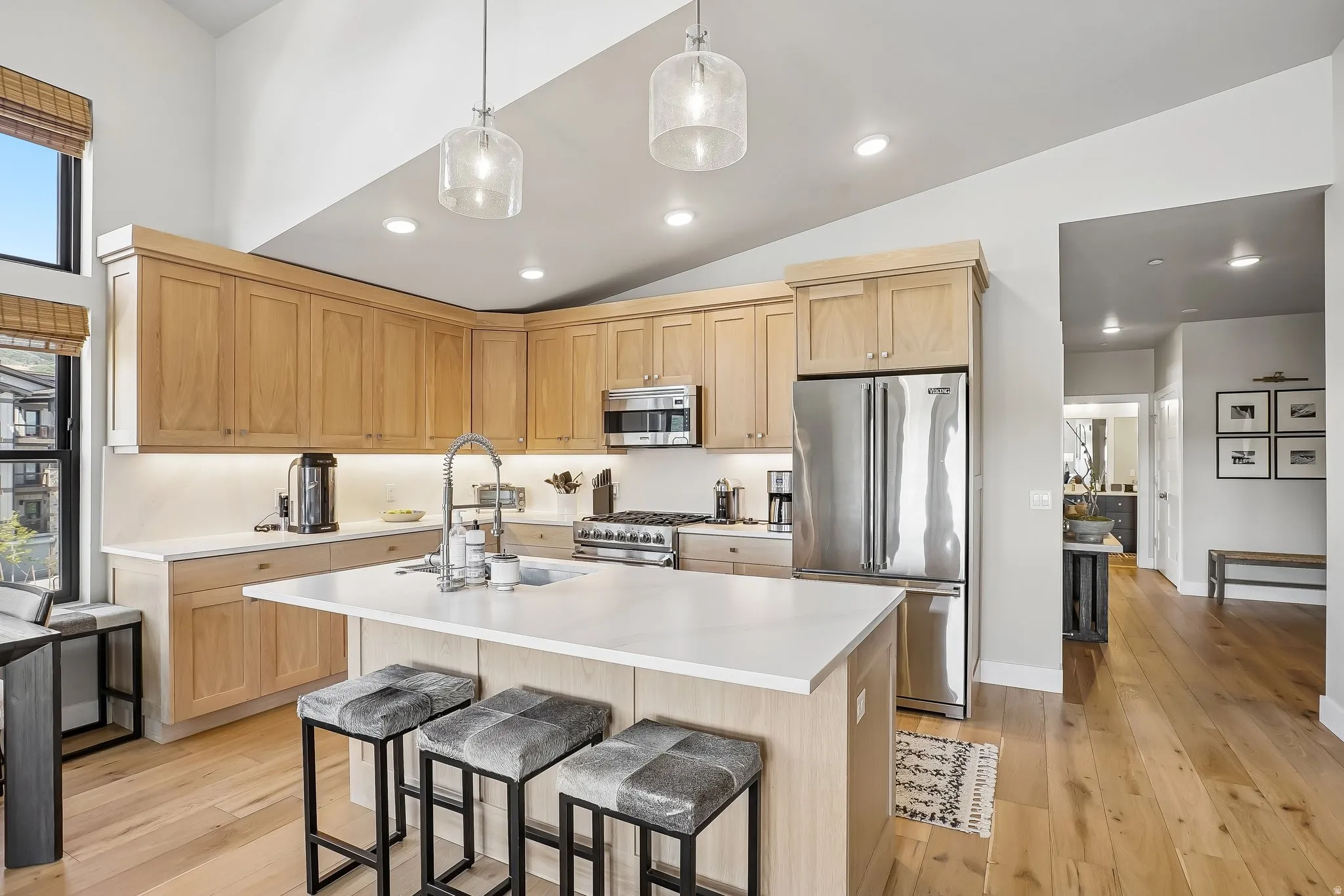 Kitchen featuring wood-finish cabinetry, stainless steel appliances, and a central island with a white countertop