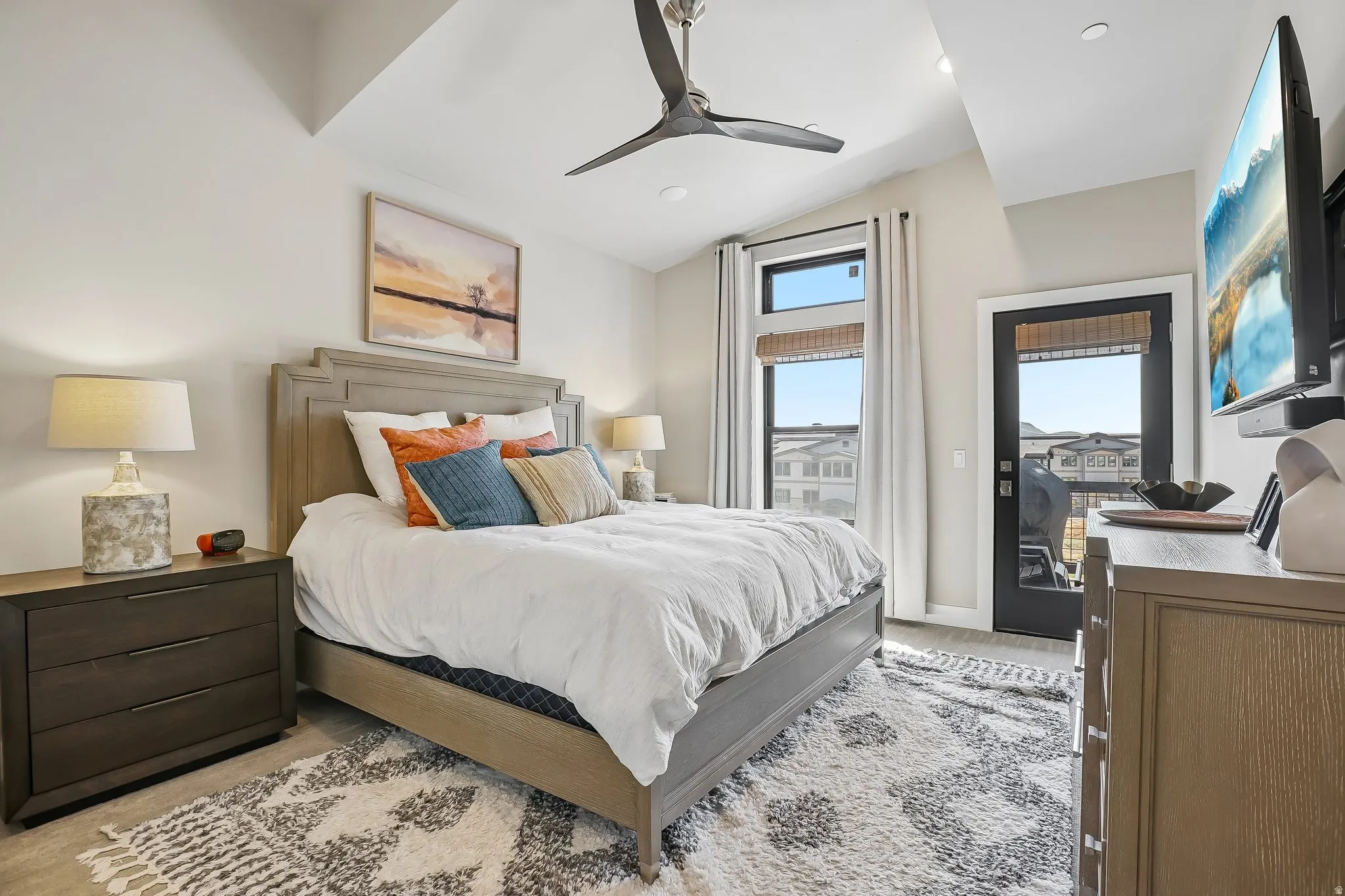Bedroom featuring a vaulted ceiling, ceiling fan, and light-colored walls