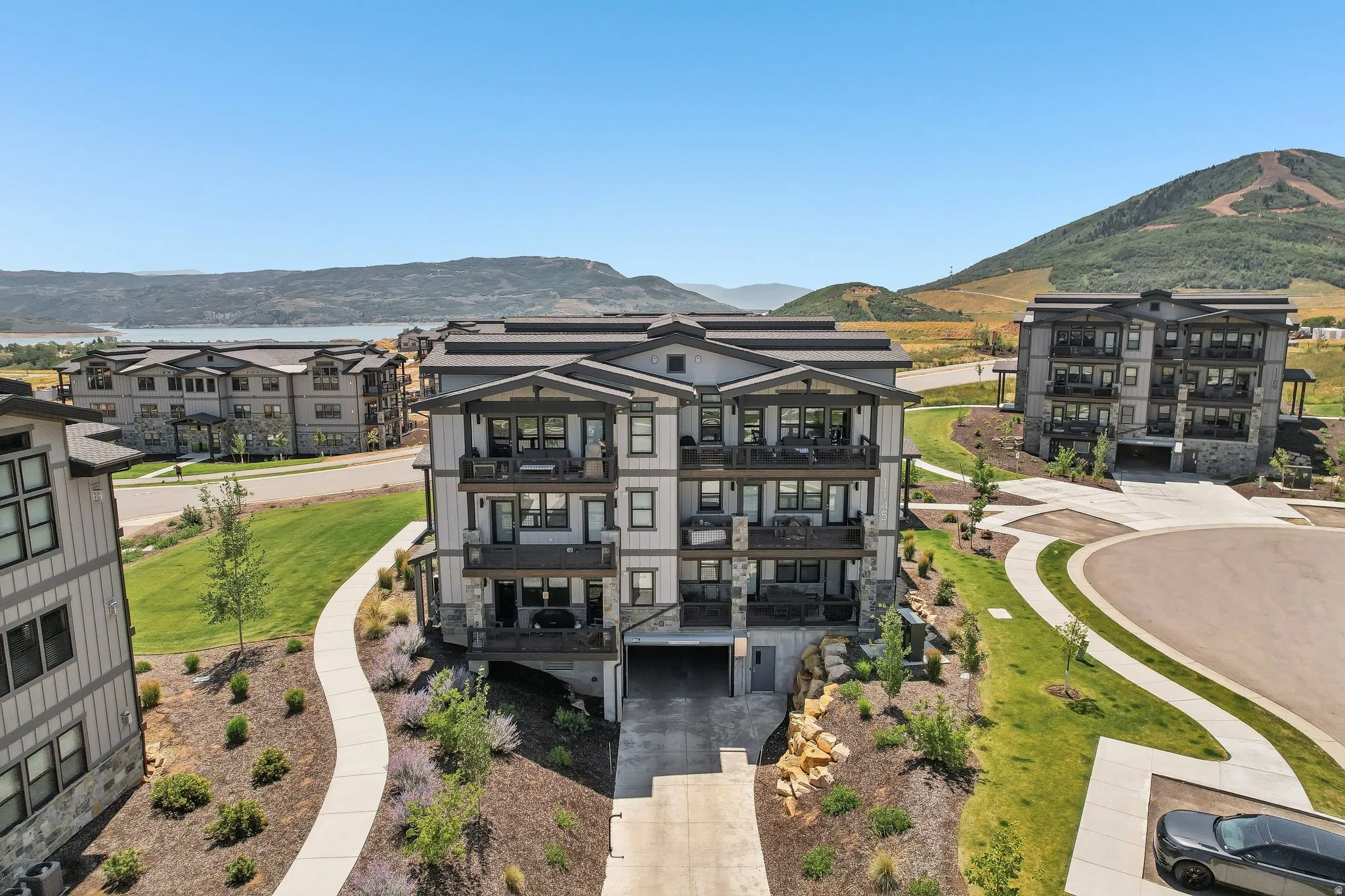 Multi-story residential building featuring balconies and a stone and siding exterior