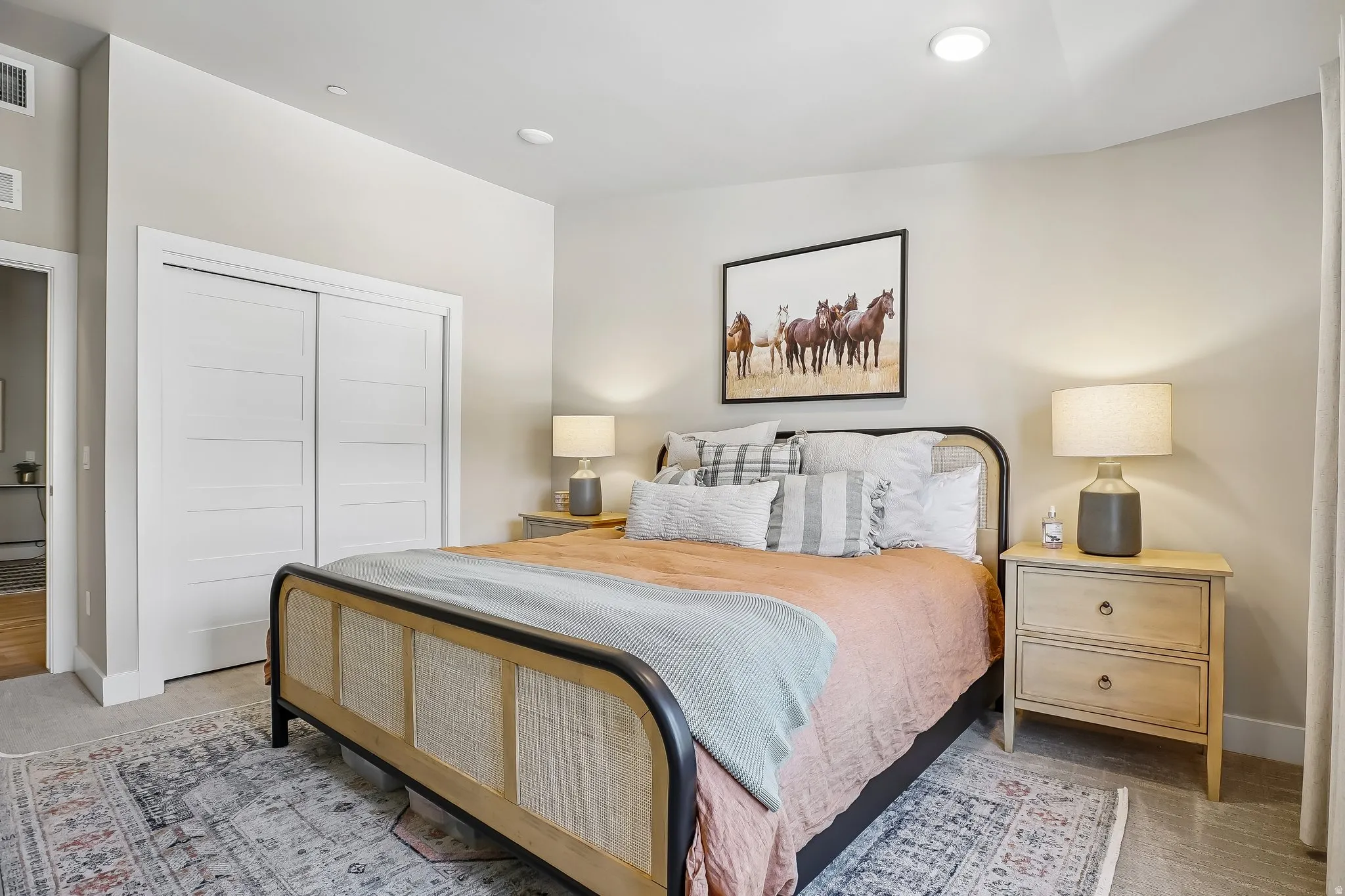 Bedroom featuring plush carpeting, recessed lighting, and a closet with modern sliding doors