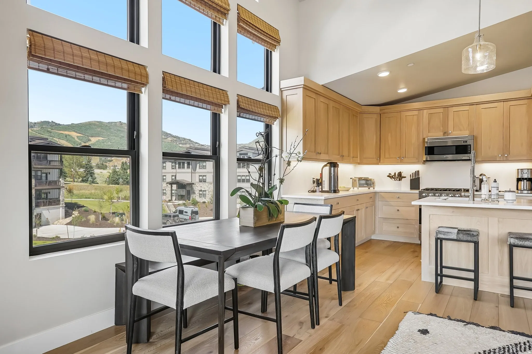 Two-story windows with woven Roman shades