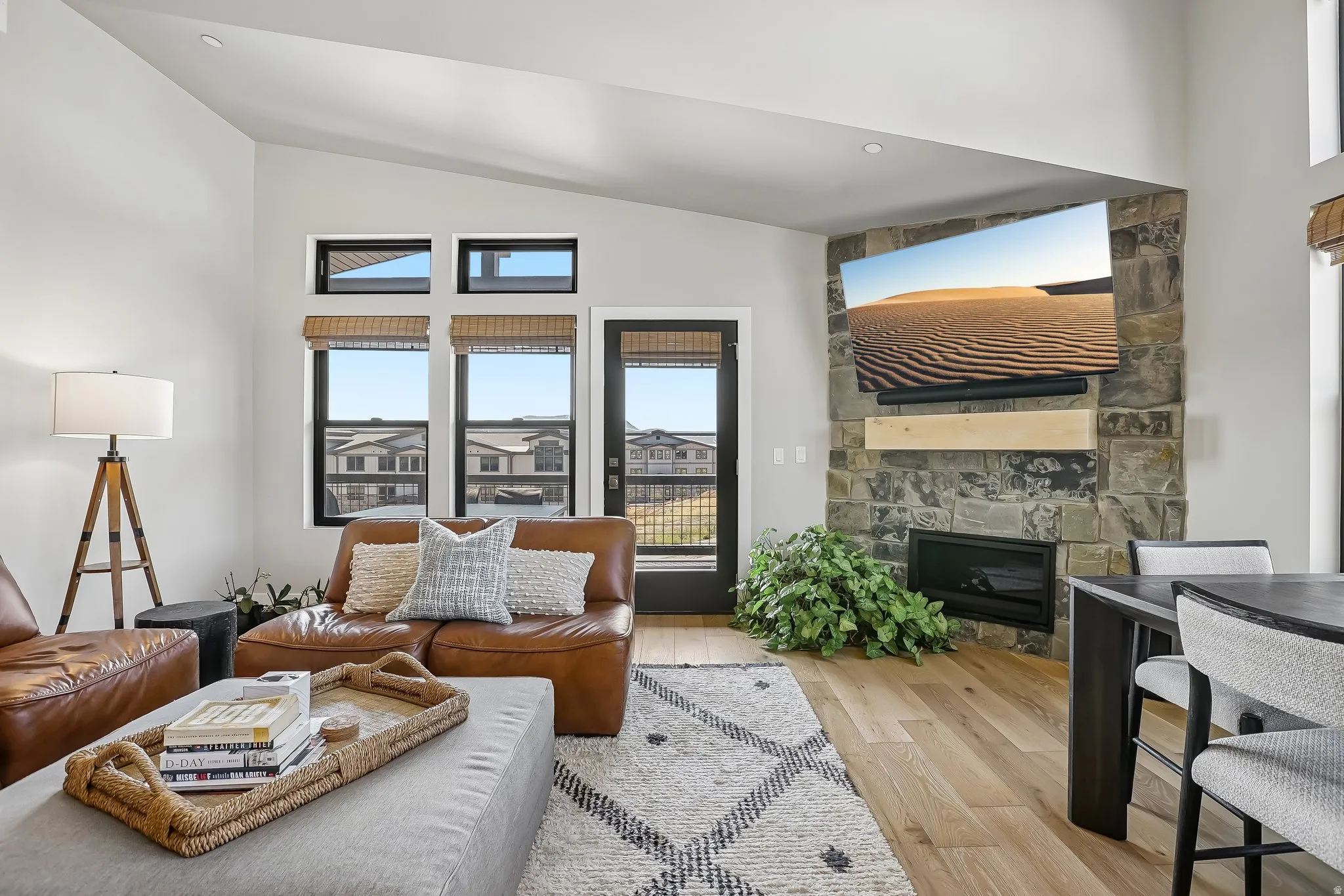 Living area featuring a stone accent wall with an integrated fireplace and wood mantel