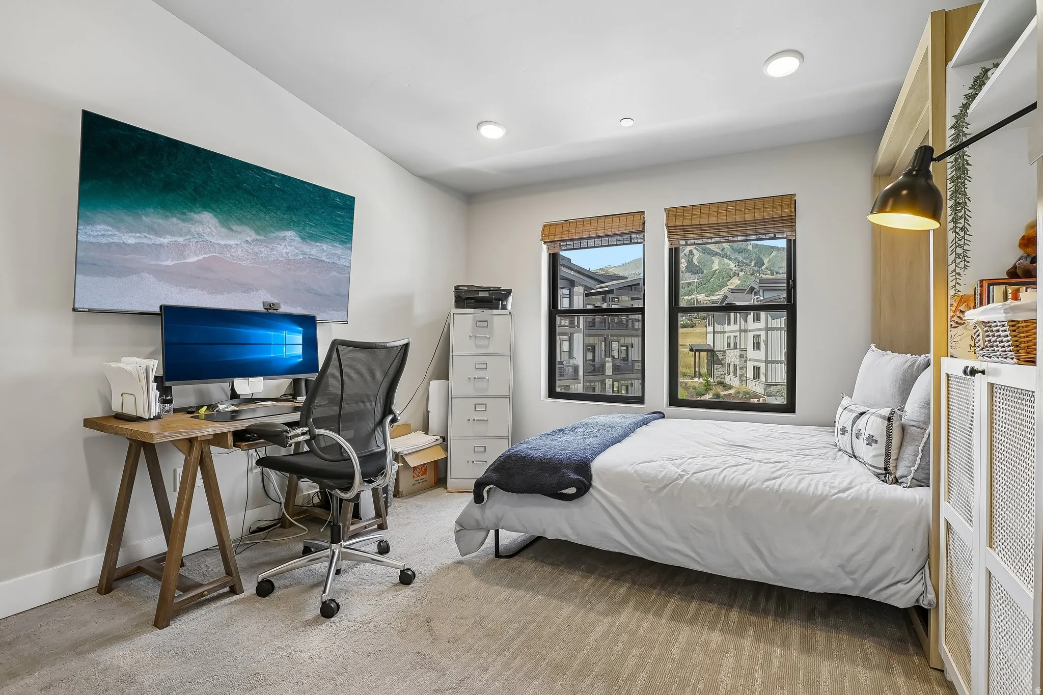 Room with recessed lighting, light-toned carpeting, and two windows with mountain scenery
