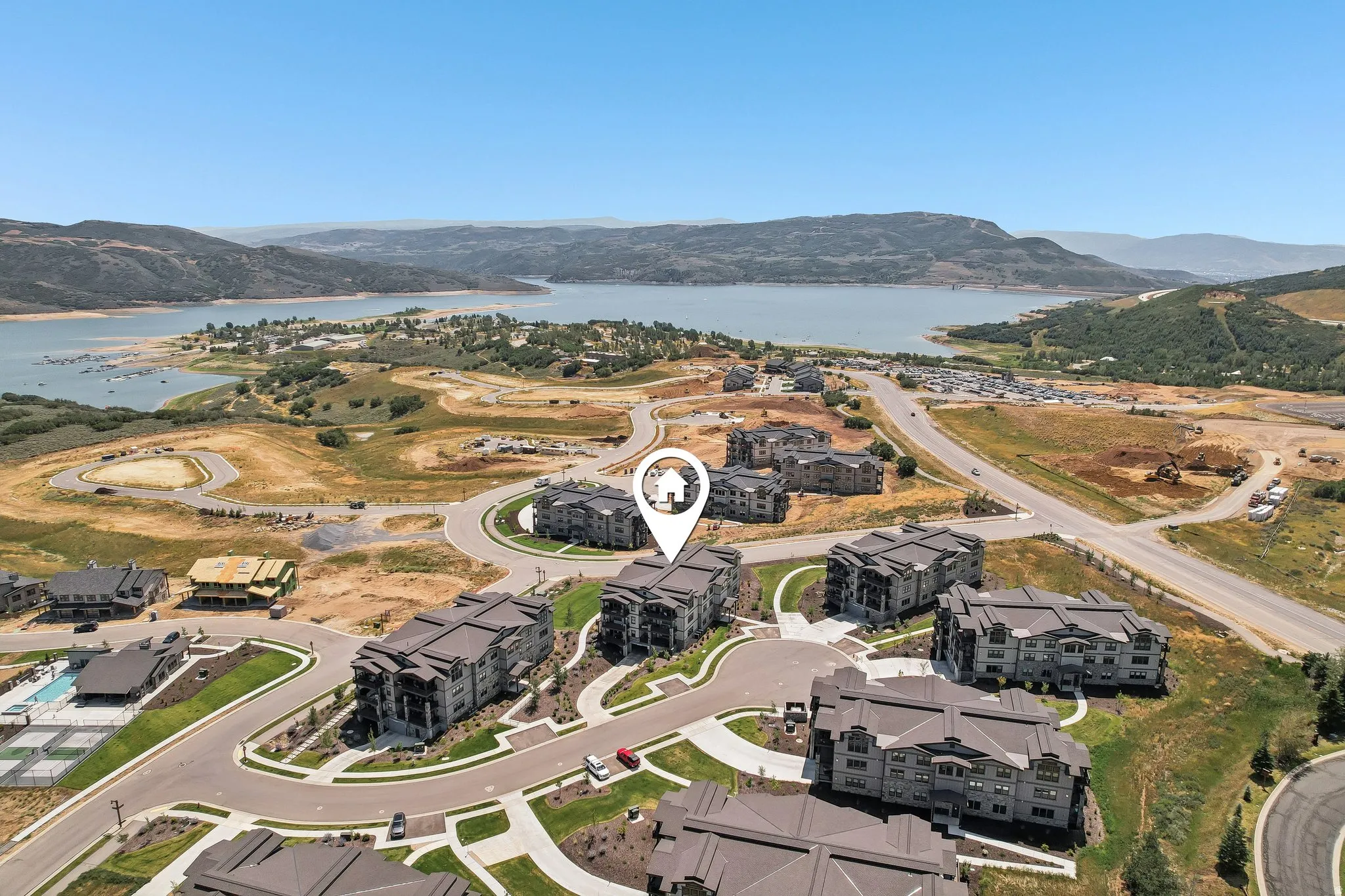 Aerial perspective showcasing the surrounding landscape with a prominent body of water and distant mountains