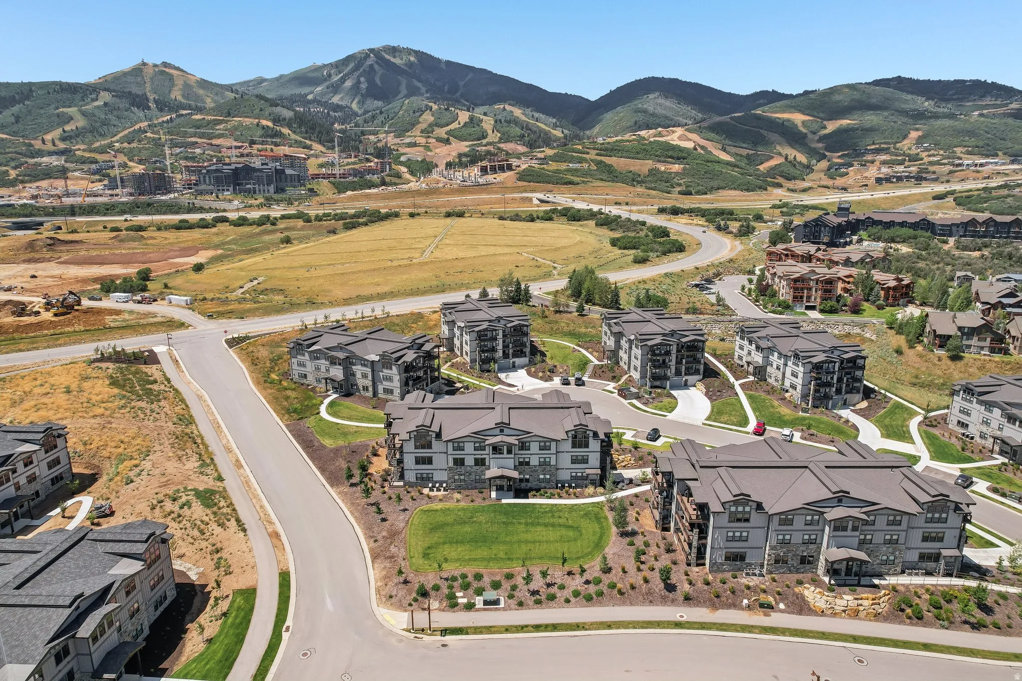 Modern multi-story residential buildings featuring dark-toned siding and pitched roofs