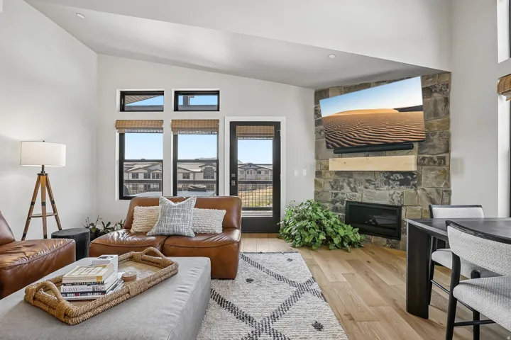 Living area featuring a stone accent wall with an integrated fireplace and wood mantel
