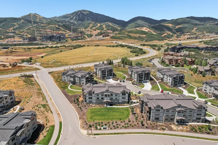 Modern multi-story residential buildings featuring dark-toned siding and pitched roofs