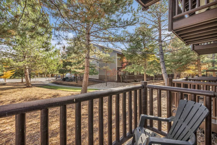 Covered balcony with wood railings