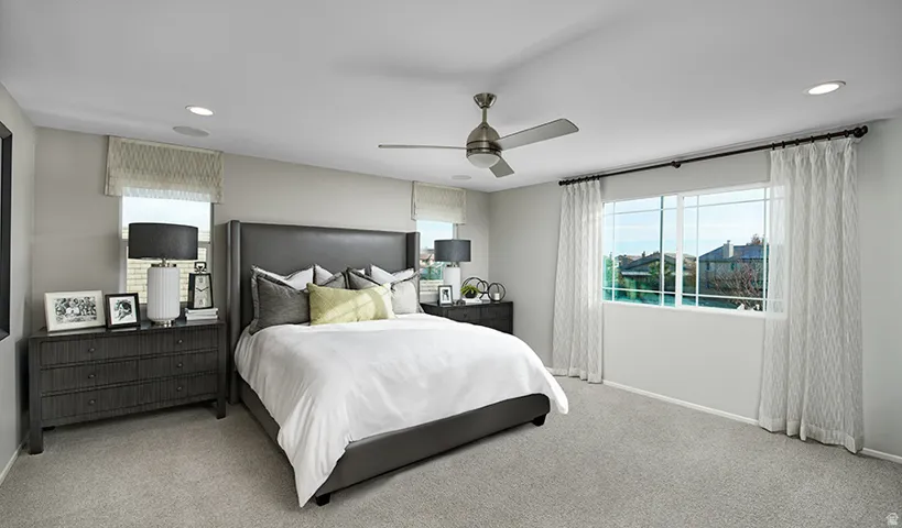Carpeted room featuring a ceiling fan with integrated lighting, recessed lighting, and multiple windows