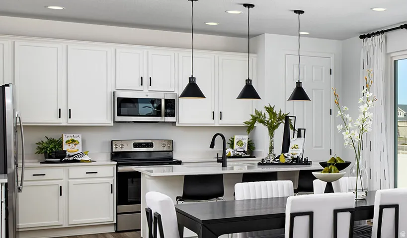 Modern kitchen featuring white cabinetry, stainless steel appliances, and a central island with bar seating