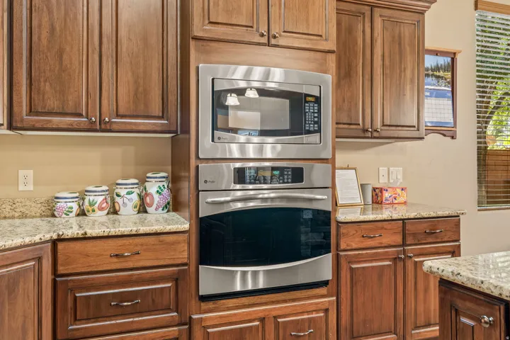 Built-in stainless steel microwave and wall oven with surrounding wood cabinetry