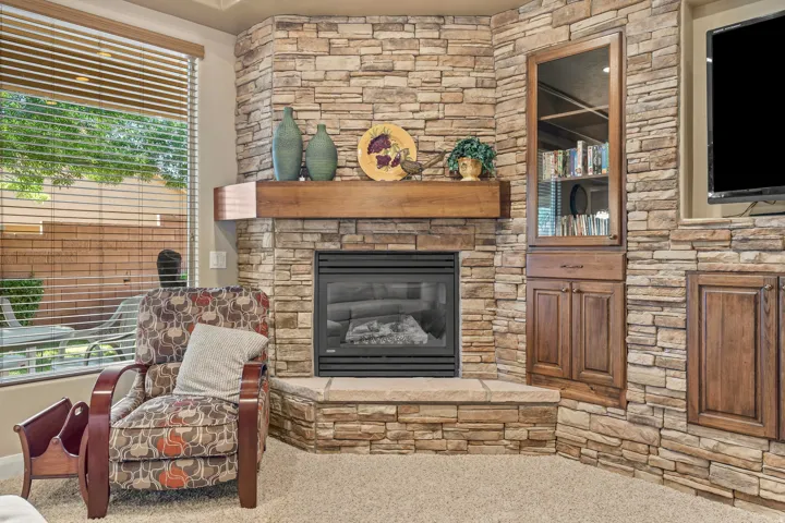 Stacked stone fireplace with a substantial wood mantel