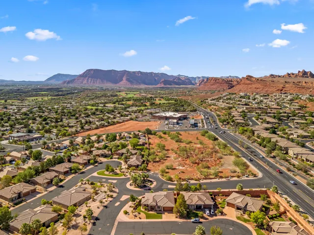 Expansive aerial capturing residential properties amidst natural desert landscaping