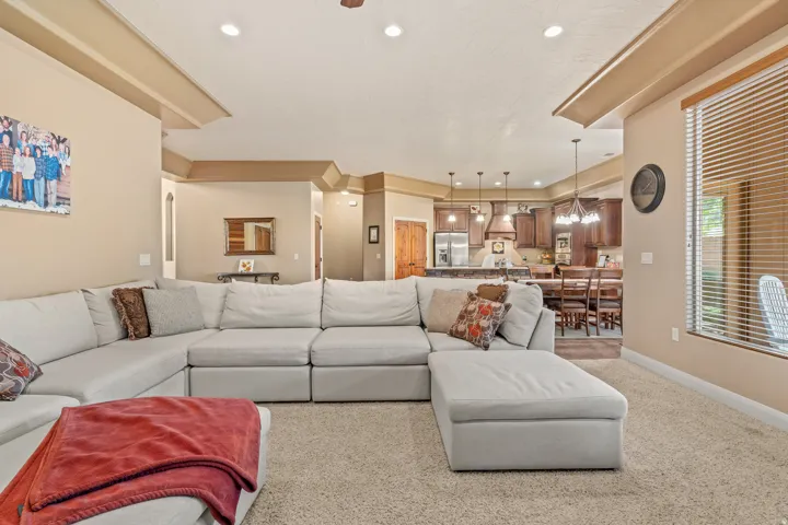 Spacious living area featuring neutral carpeting and recessed ceiling lighting