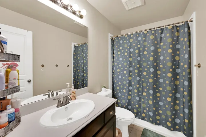 Bathroom featuring a vanity with an oval undermount sink and a neutral countertop