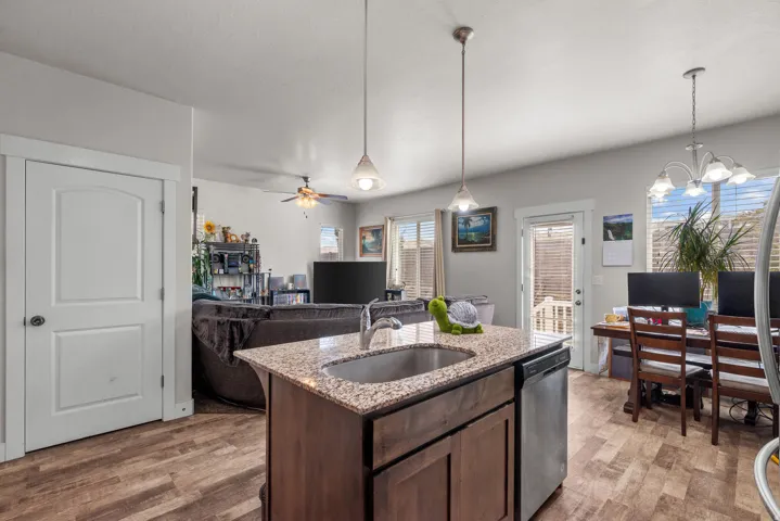 Kitchen island with granite-finish countertop and undermount sink