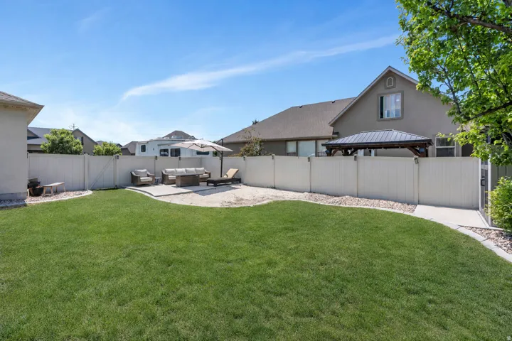 Manicured lawn with a curved concrete path and gravel borders