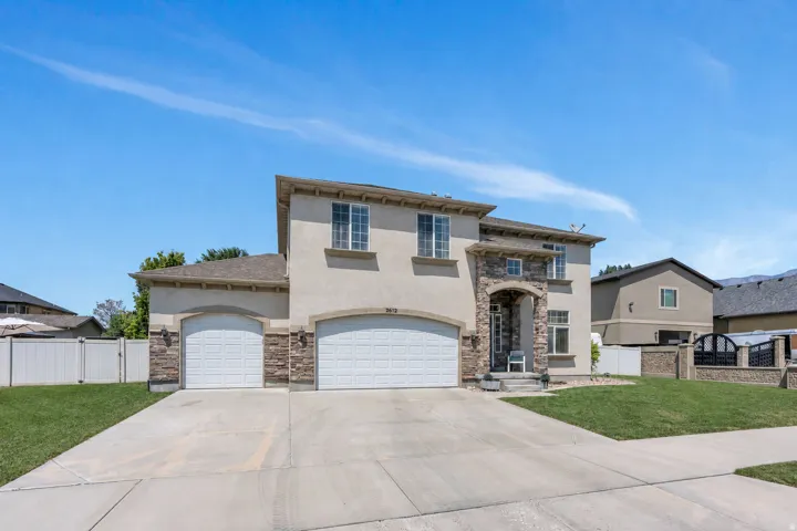 Stucco exterior with stone accents and an arched entry