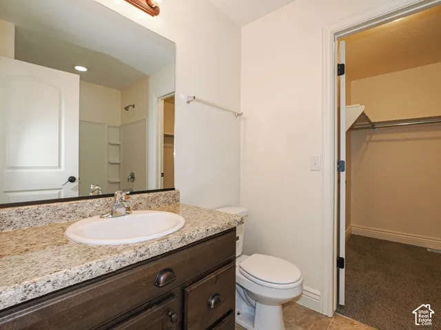 Vanity with a light-toned countertop and an integrated sink