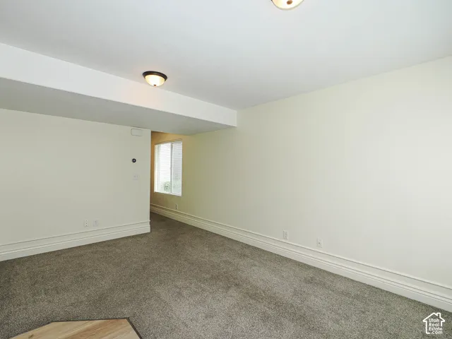 Recessed ceiling lighting, textured wall finishes, and a window with blinds