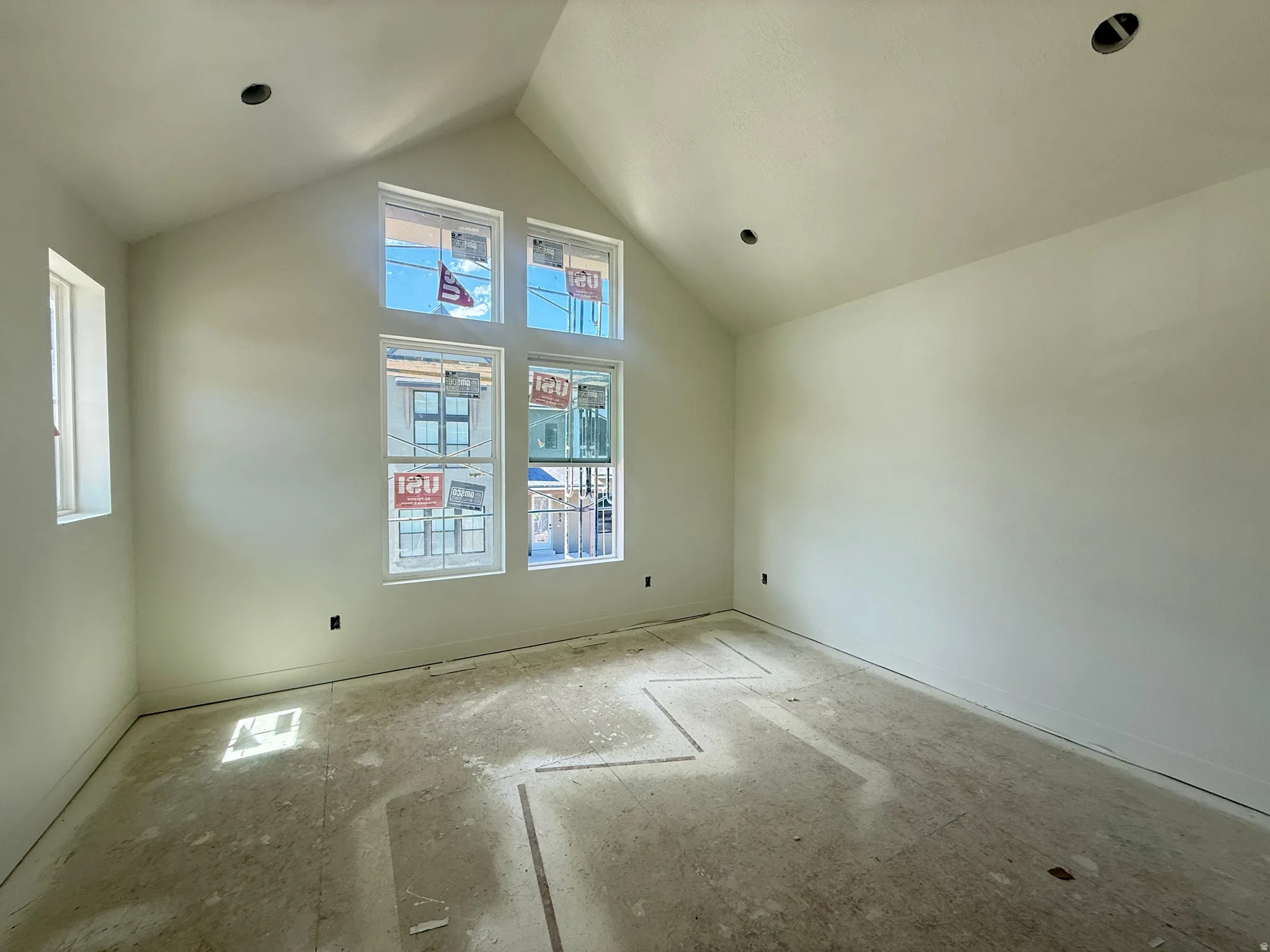 Owner's Suite featuring a vaulted ceiling and ample light